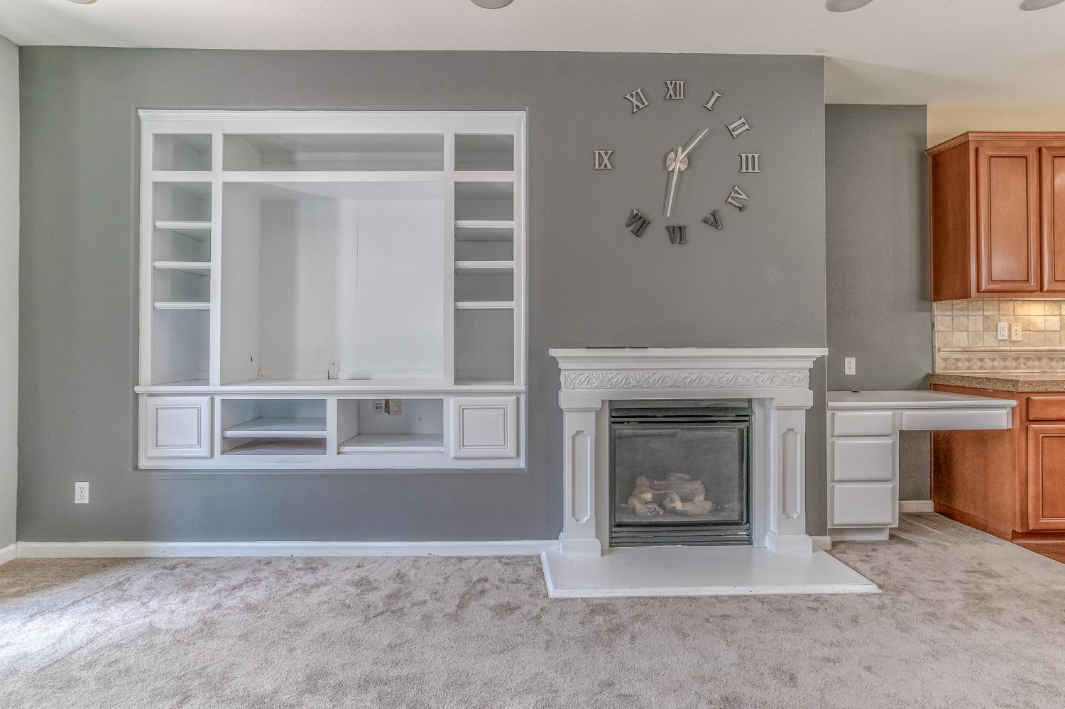 188 Thomsen Road Lathrop, CA 95330 - Photo 12 of 27 a view of livingroom with a fireplace cabinet and window