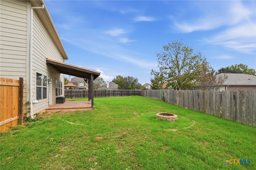 316 Housefinch Loop Leander, TX 78641 - Photo 6 of 37 Expansive backyard with covered patio and fire pit — perfect for entertaining.