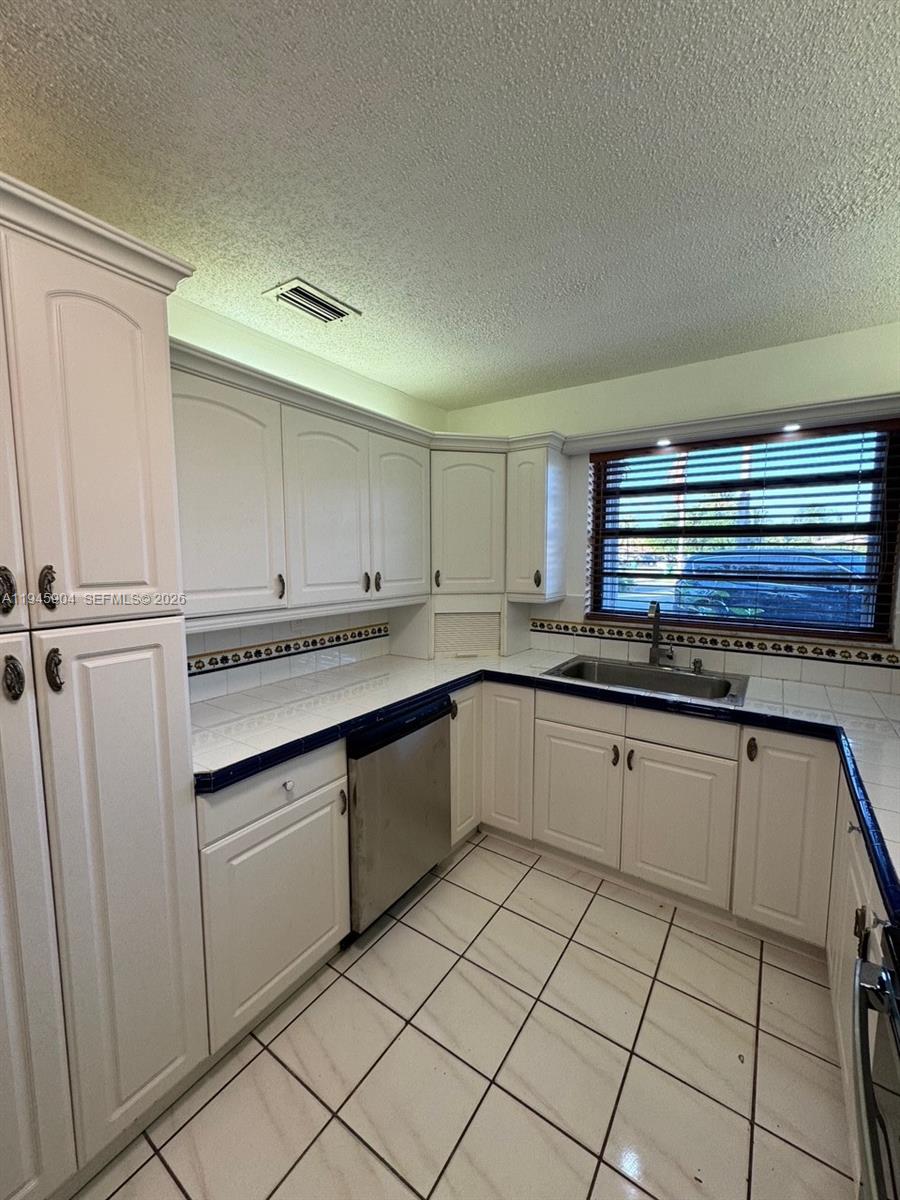 1045 Southwest 122nd Court Miami, FL 33184 - Photo 11 of 44 a kitchen with a sink and cabinets