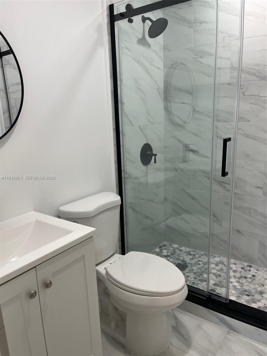 1045 Southwest 122nd Court Miami, FL 33184 - Photo 30 of 44 a bathroom with a sink toilet and shower