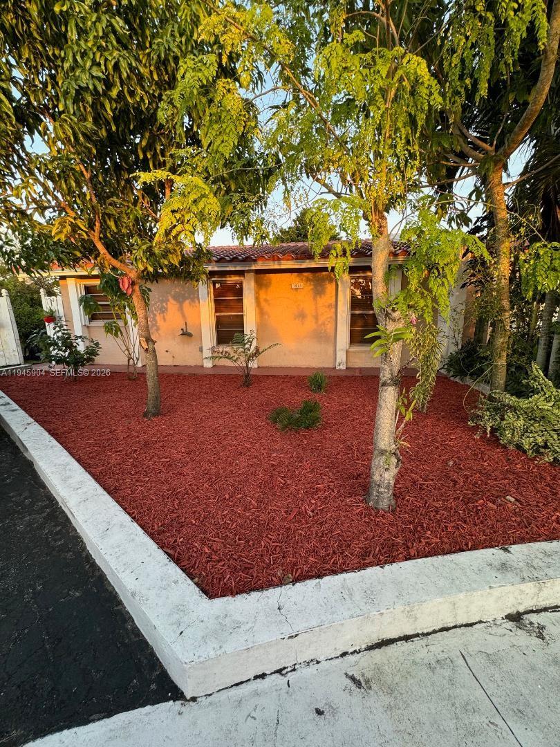 1045 Southwest 122nd Court Miami, FL 33184 - Photo 3 of 44 a view of a backyard with large trees