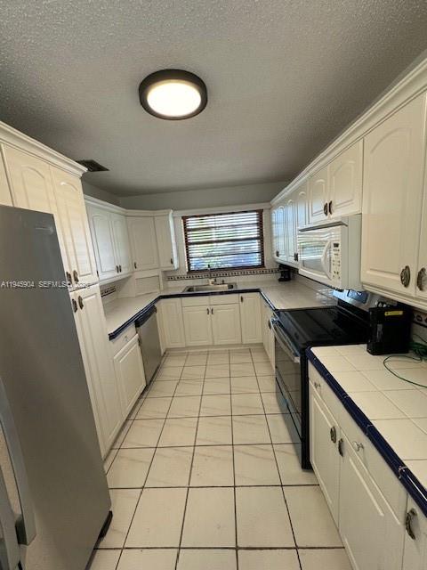 1045 Southwest 122nd Court Miami, FL 33184 - Photo 37 of 44 a kitchen with stainless steel appliances cabinets a sink and a stove