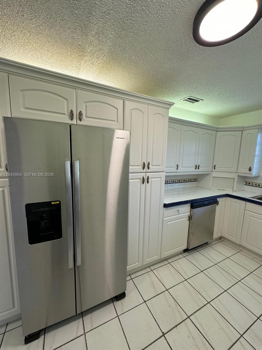 1045 Southwest 122nd Court Miami, FL 33184 - Photo 4 of 44 a kitchen with a refrigerator and a sink