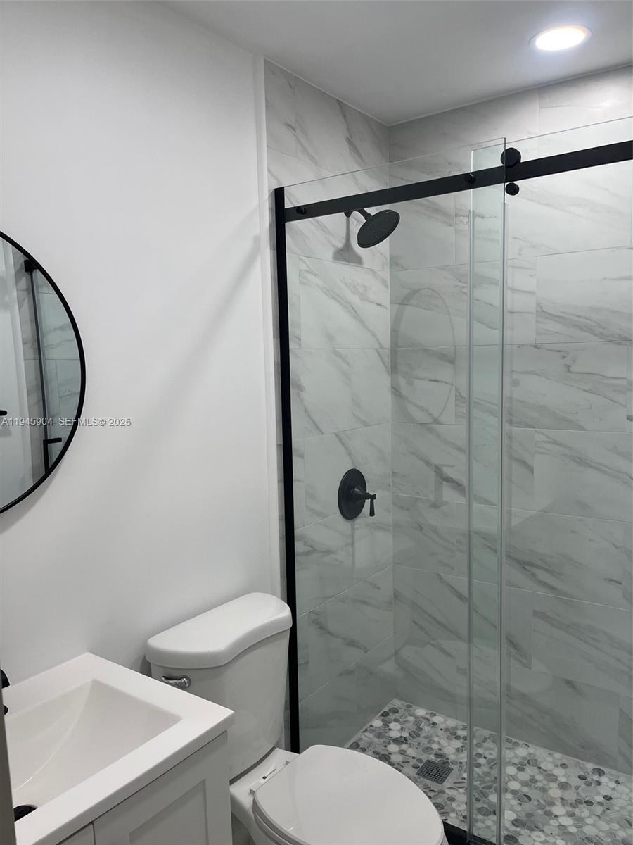 1045 Southwest 122nd Court Miami, FL 33184 - Photo 8 of 44 a white toilet sitting next to a bathroom sink