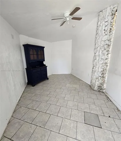 a living room with a black white checkered floor with a rug and a rug