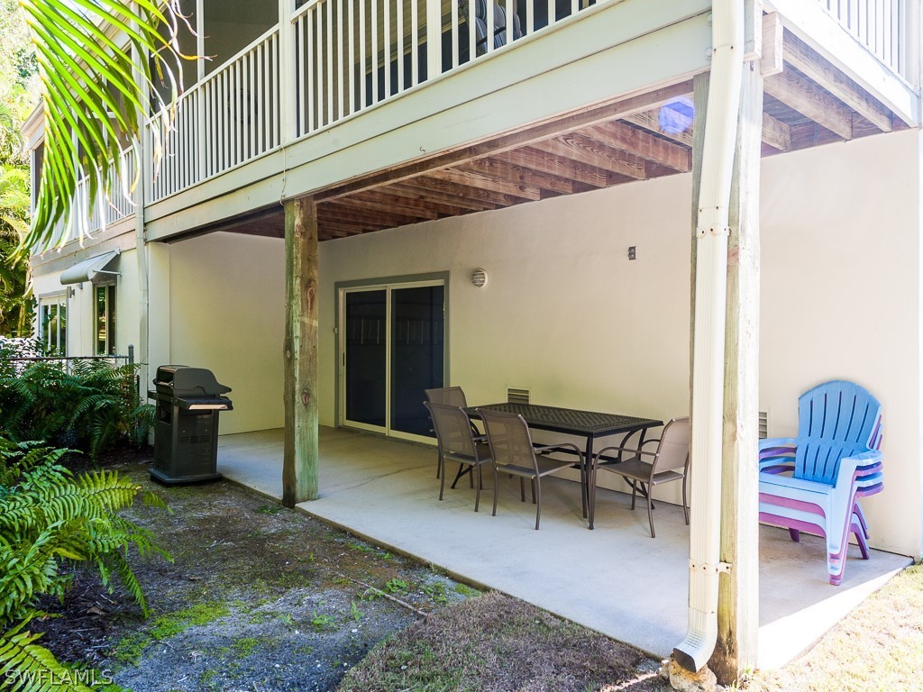 965 Beach Road Sanibel, FL 33957 - Photo 27 of 34 a view of a patio with table and chairs and potted plants