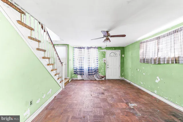 a view of a room with wooden floor and windows