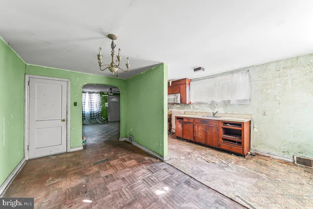 a kitchen with stainless steel appliances granite countertop a stove a sink dishwasher and a refrigerator with wooden floor