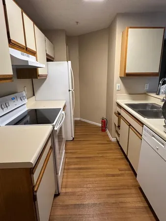 a kitchen with wooden cabinets and sink