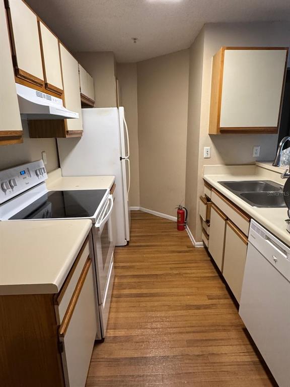 956 Salt Pond Place, Unit 304 Altamonte Springs, FL 32714 - Photo 1 of 5 a kitchen with wooden cabinets and sink