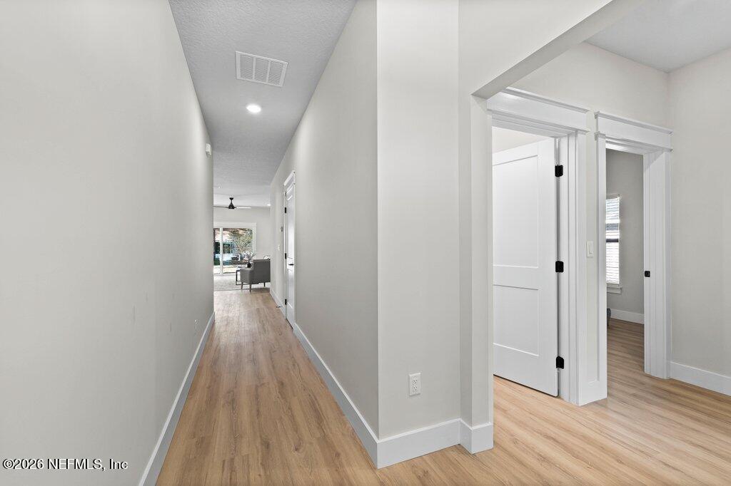 9019 Hipps Road Jacksonville, FL 32222 - Photo 5 of 35 a view of a hallway with wooden floor