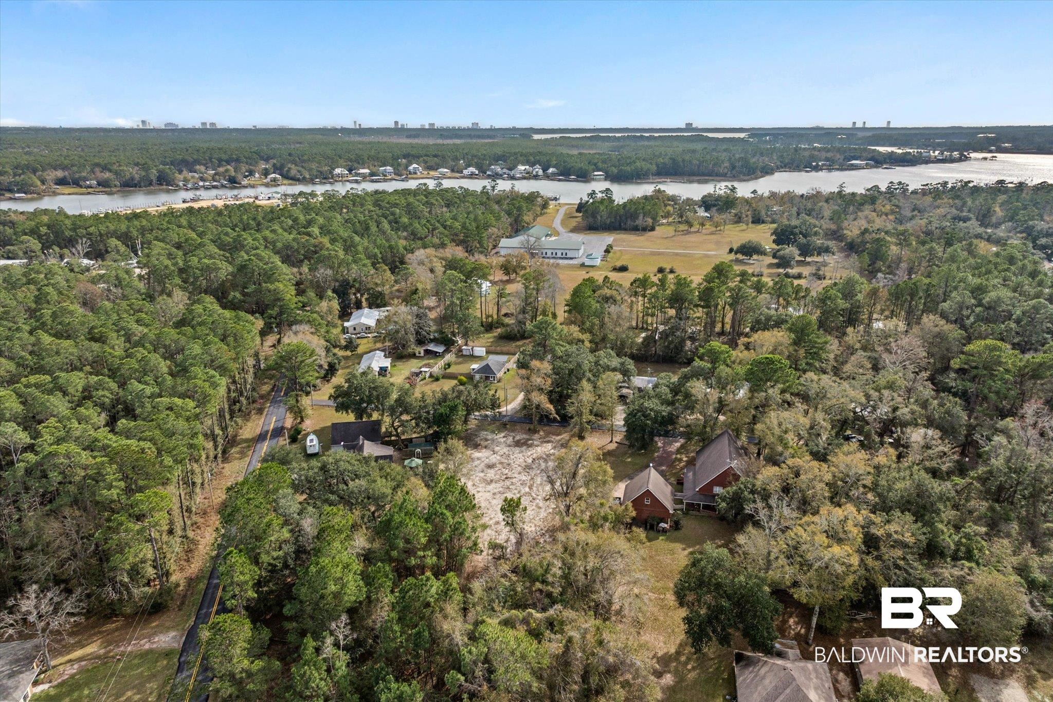 17065 Britt Lane Bon Secour, AL 36511 - Photo 1 of 15 Aerial view of property and surrounding area with a forest and a large body of water