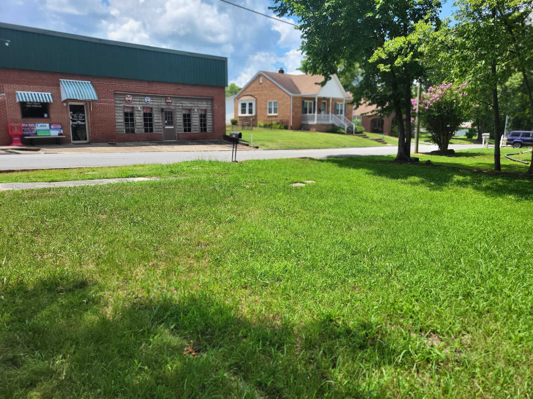 1 Maple Avenue Camden, TN 38320 - Photo 3 of 9 a front view of a house with a yard
