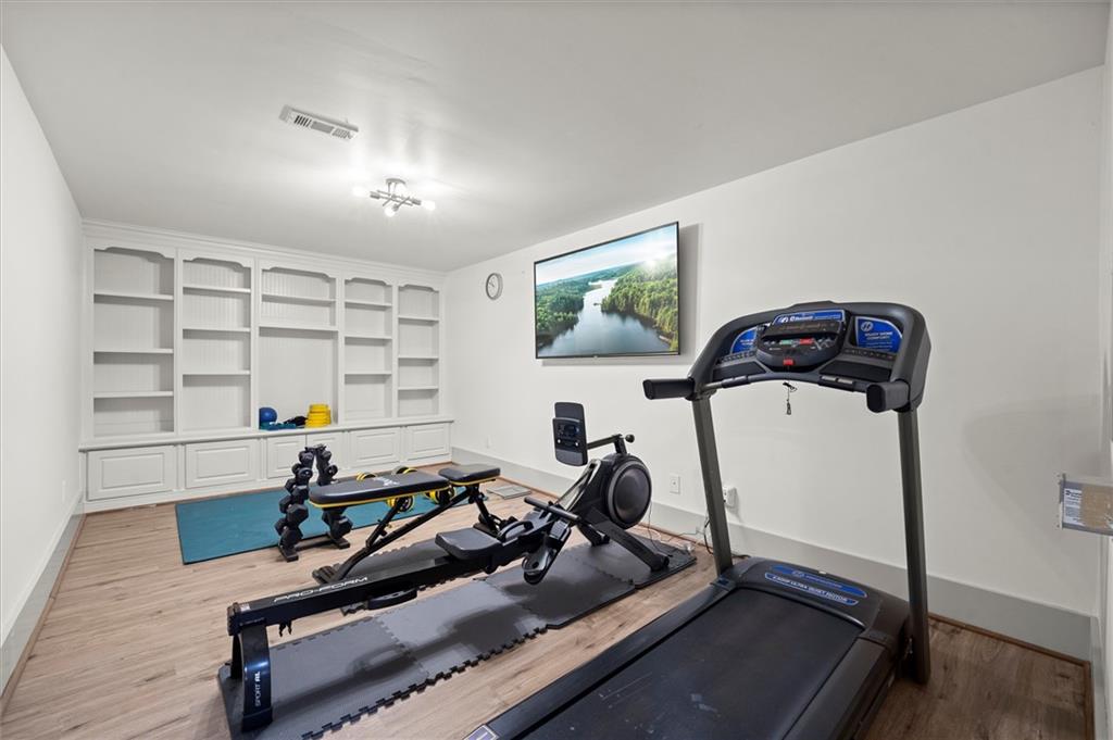 6229 Grand Loop Road Sugar Hill, GA 30518 - Photo 59 of 93 a room with gym equipment and a large window
