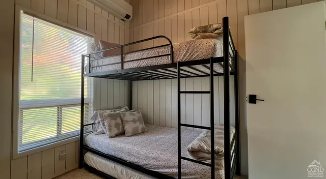 a bedroom with furniture and a wooden floor