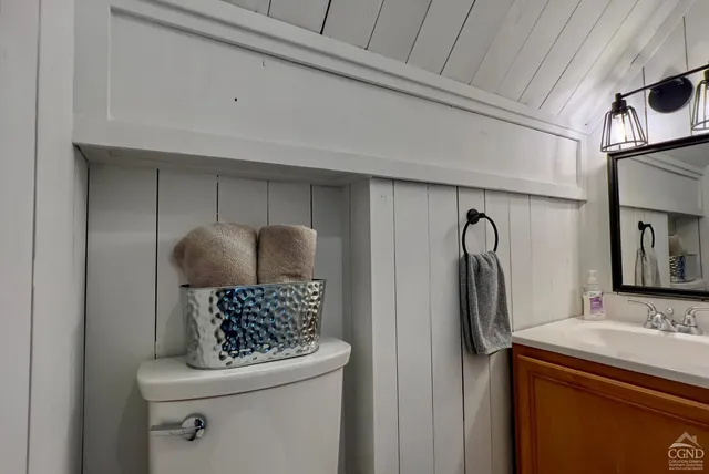 a living room with furniture and a mirror