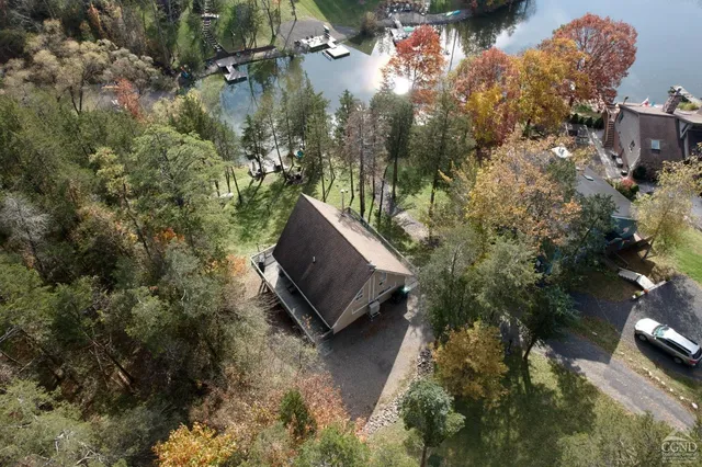 an aerial view of a house with a yard basket ball court and outdoor seating