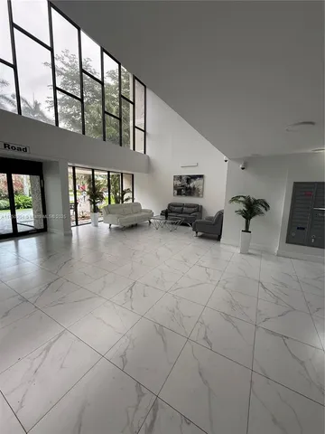 a view of a livingroom with furniture and a window