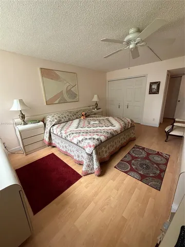 a bedroom with two beds and painting on the wall