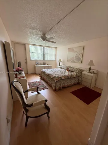 a bedroom with two beds and window