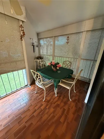 a living room with a table and chairs