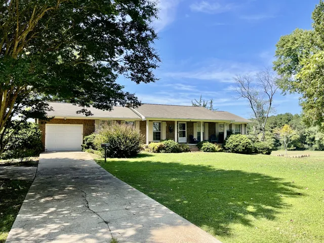 a front view of a house with a yard and porch