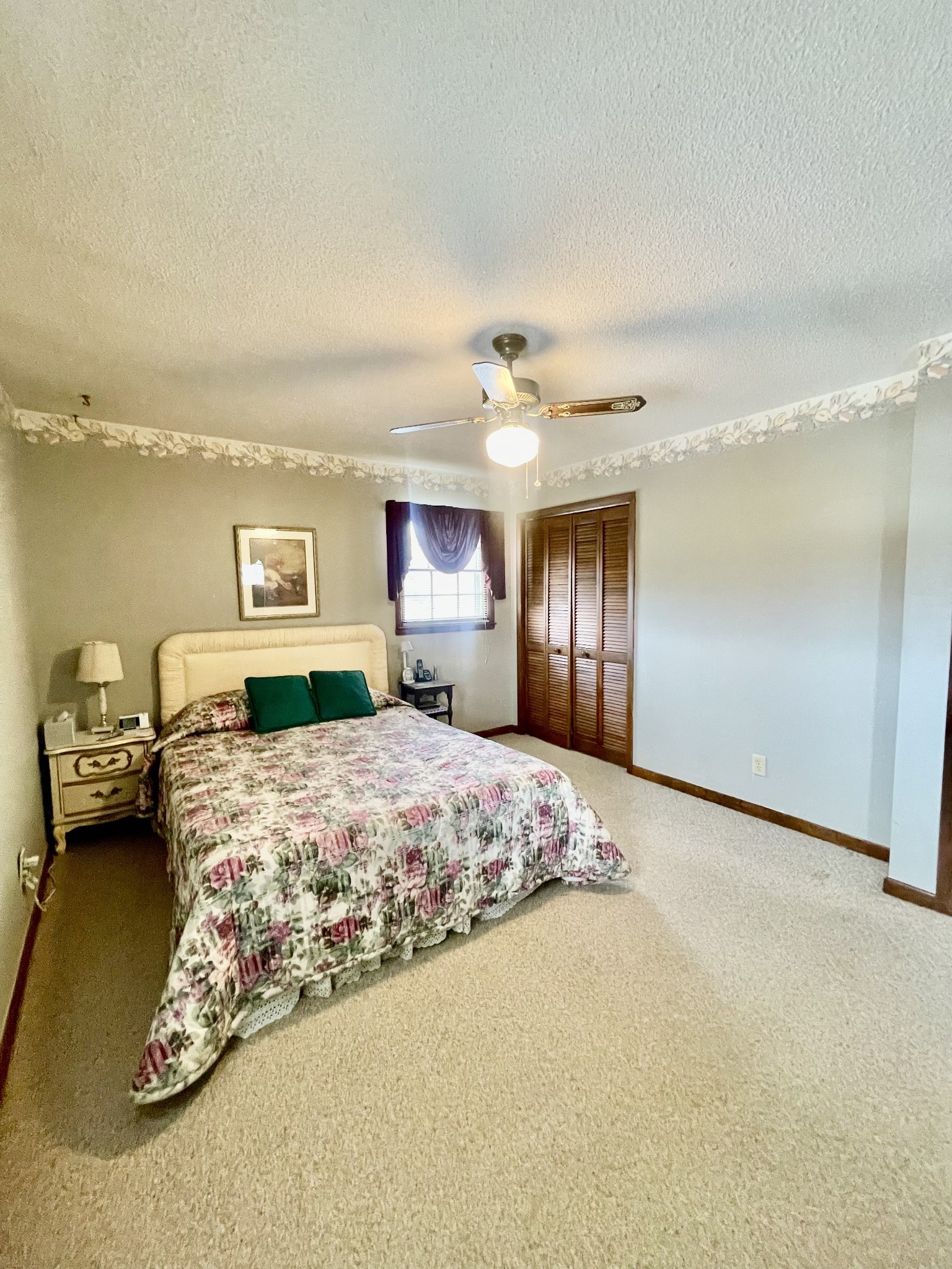 336 Second Creek Road Five Points, TN 38457 - Photo 27 of 37 a bedroom with a large bed and a chandelier