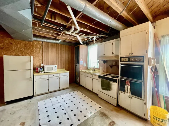 a kitchen with a sink cabinets stainless steel appliances and a counter top space