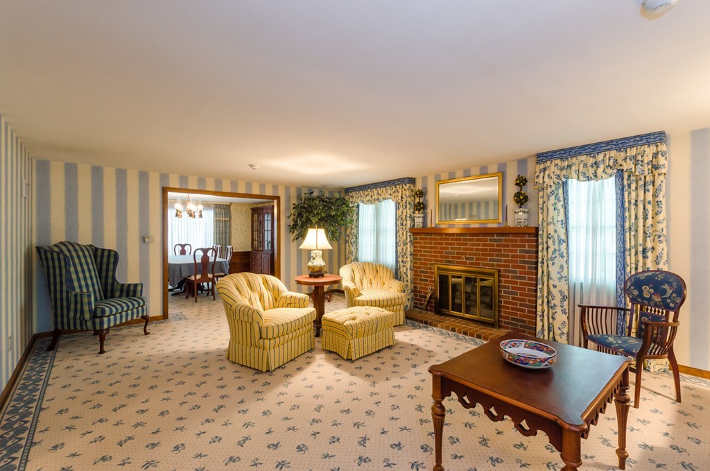 60 Birch Meadow Road Merrimac, MA 01860 - Photo 2 of 27 a living room with furniture a fireplace and a table