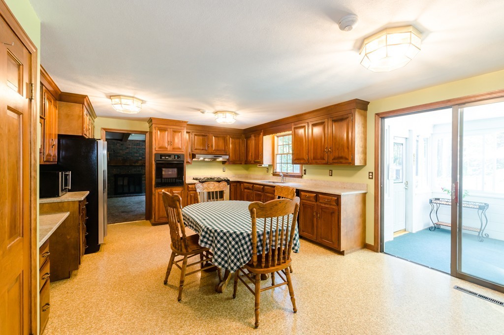 60 Birch Meadow Road Merrimac, MA 01860 - Photo 4 of 27 a dining room with furniture and a kitchen view