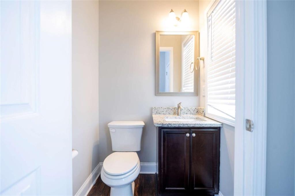 68 Crescent Commons Drive Dallas, GA 30157 - Photo 14 of 26 a bathroom with a granite countertop toilet a sink and a mirror