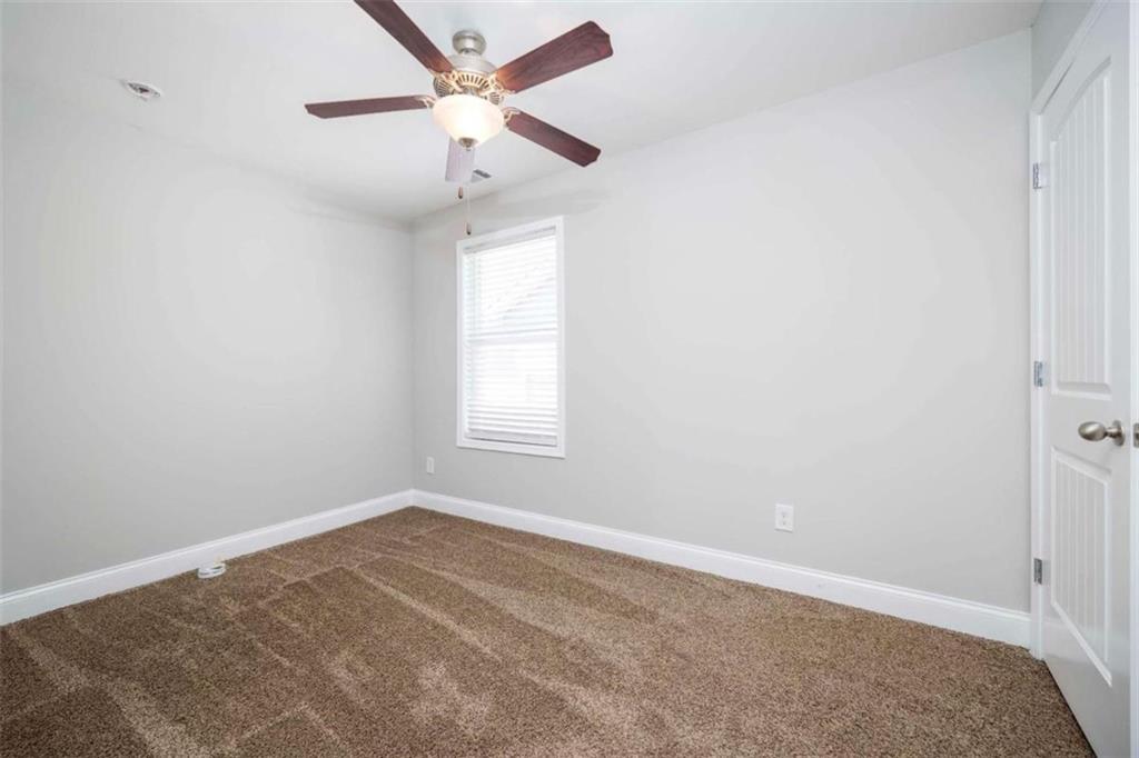 68 Crescent Commons Drive Dallas, GA 30157 - Photo 15 of 26 an empty room with a window and a fan