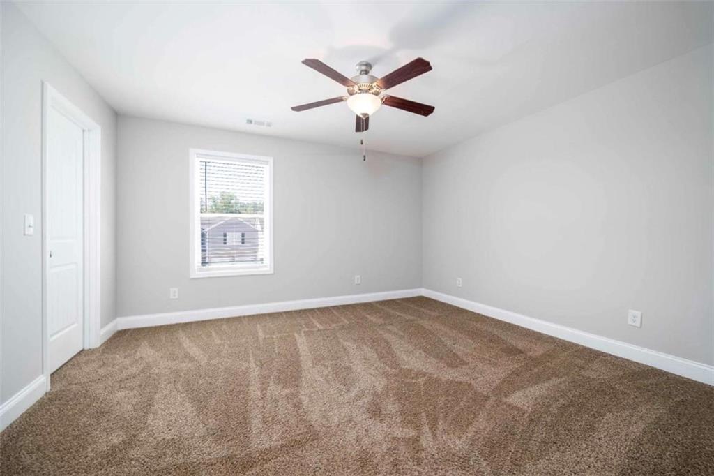 68 Crescent Commons Drive Dallas, GA 30157 - Photo 16 of 26 an empty room with window and ceiling fan