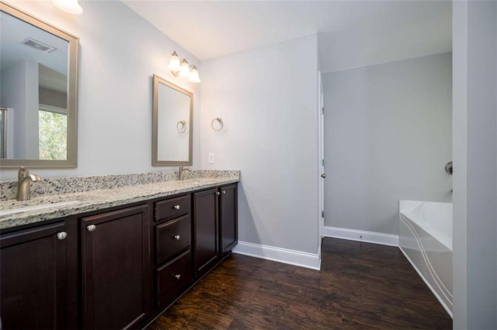 68 Crescent Commons Drive Dallas, GA 30157 - Photo 17 of 26 a bathroom with a granite countertop sink a toilet and a mirror