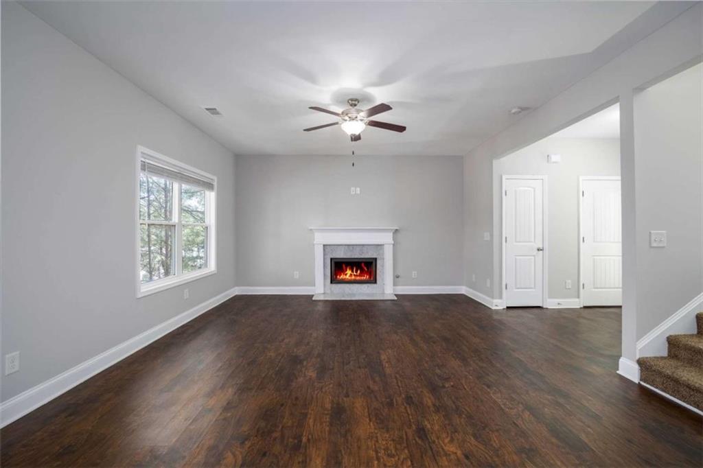 68 Crescent Commons Drive Dallas, GA 30157 - Photo 5 of 26 a view of an empty room with wooden floor and a window