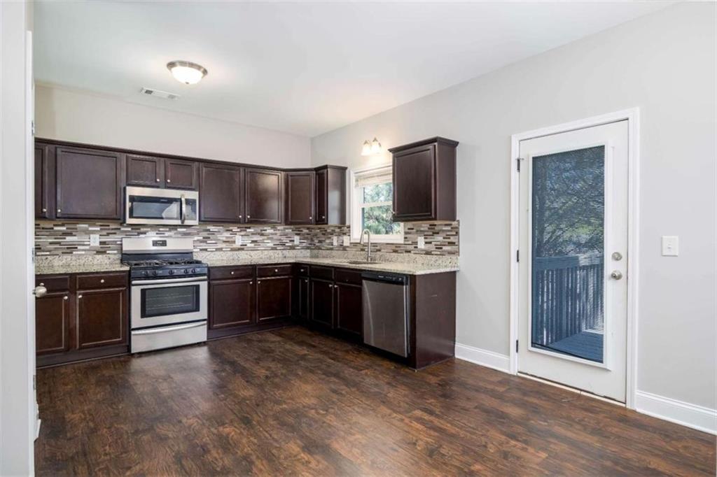 68 Crescent Commons Drive Dallas, GA 30157 - Photo 7 of 26 a large kitchen with stainless steel appliances and a stove top oven