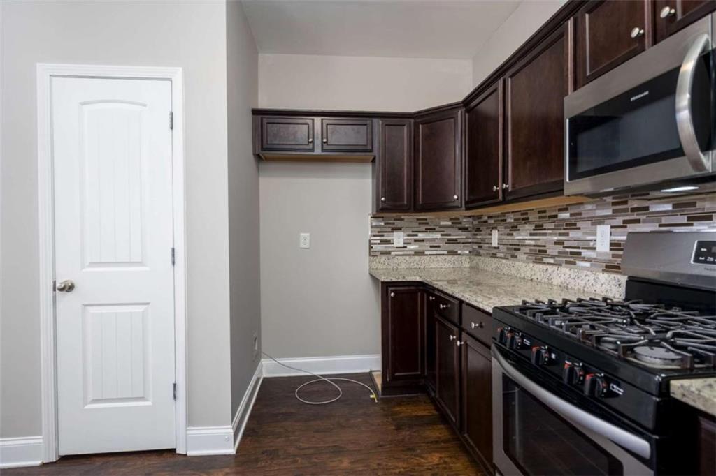 68 Crescent Commons Drive Dallas, GA 30157 - Photo 9 of 26 a kitchen with stainless steel appliances granite countertop a stove and a refrigerator