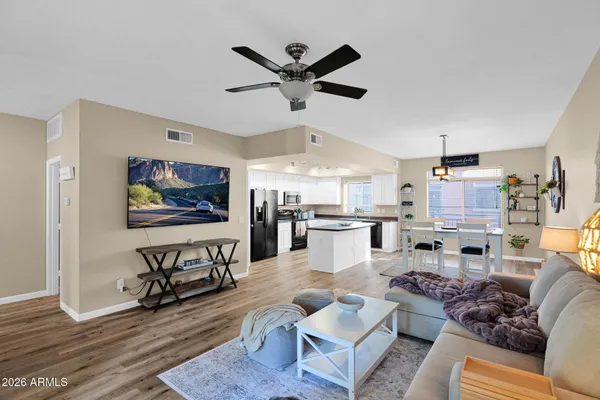 a living room with furniture and kitchen view