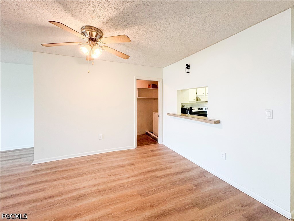 1830 Brantley Road, Unit I7 Fort Myers, FL 33907 - Photo 10 of 34 a view of a room with a ceiling fan and wooden floor