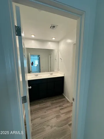 a bathroom with a sink a mirror and a toilet