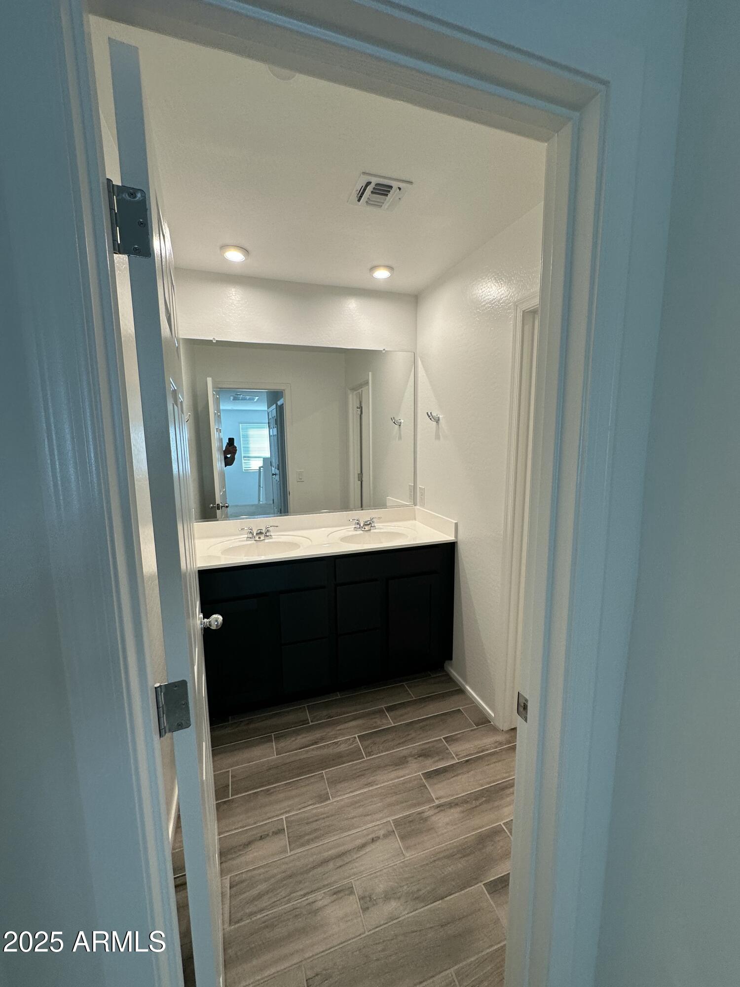 13330 West Eagle Feather Road Peoria, AZ 85383 - Photo 24 of 34 a bathroom with a sink a mirror and a toilet