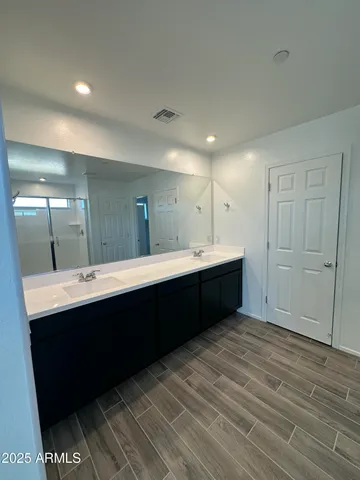 a bathroom with a double vanity sink and mirror