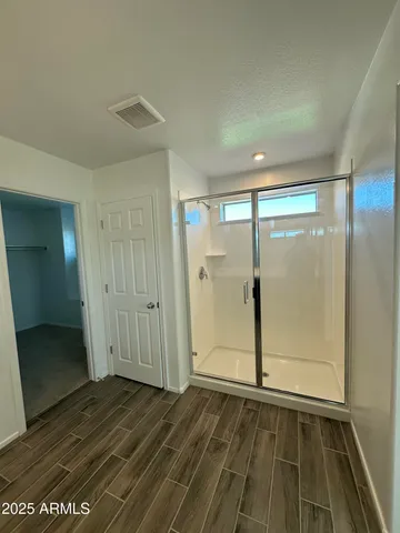 an empty room with wooden floor and door