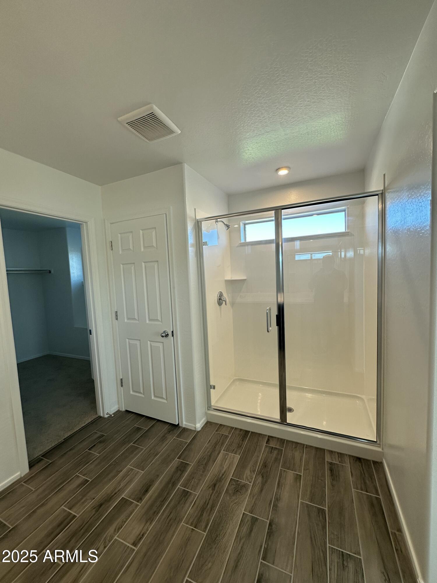 13330 West Eagle Feather Road Peoria, AZ 85383 - Photo 32 of 34 an empty room with wooden floor and door