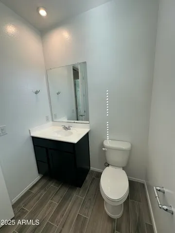 a bathroom with a sink toilet and a mirror