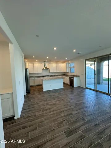a view of kitchen and hall with wooden floor