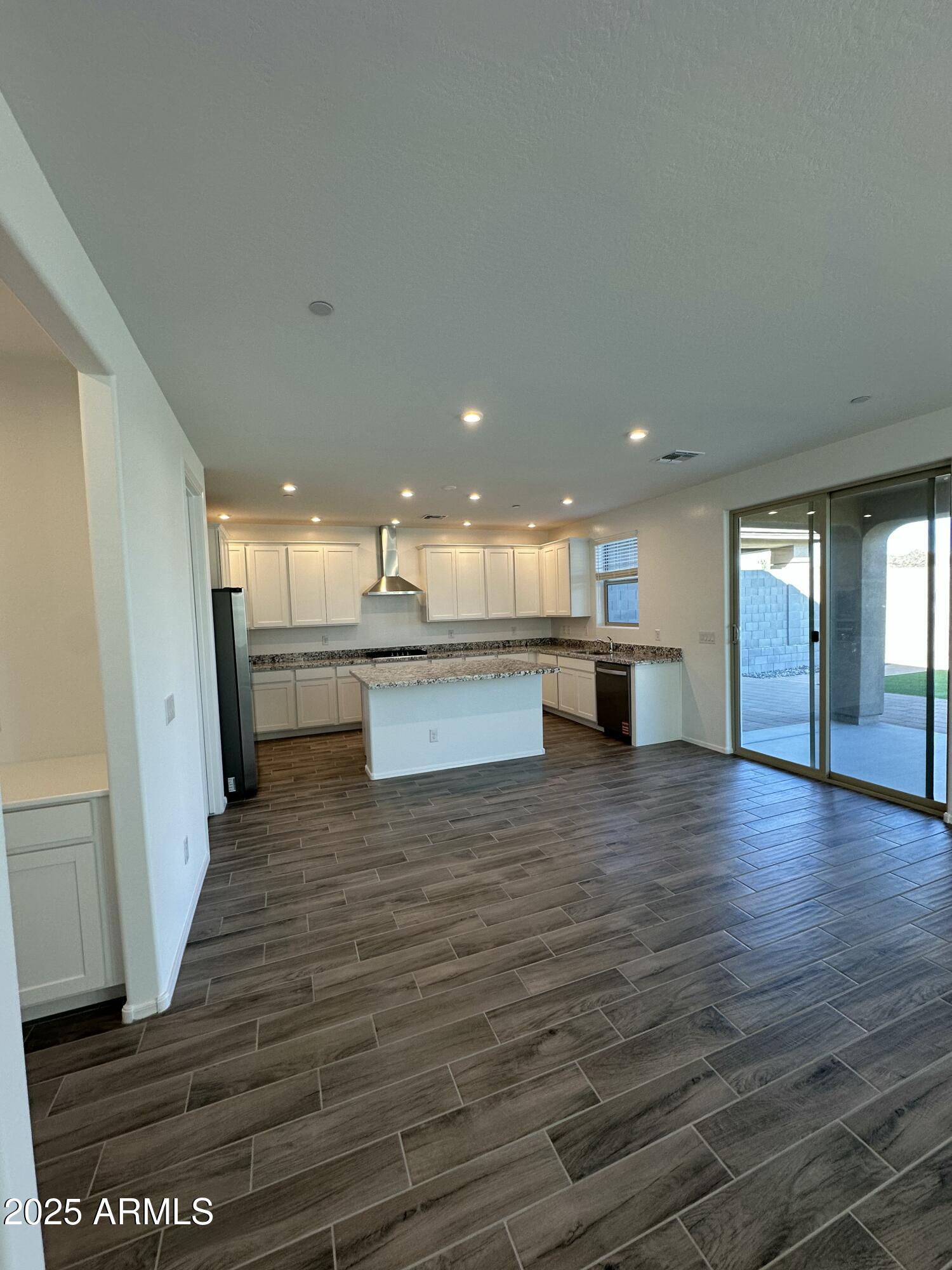 13330 West Eagle Feather Road Peoria, AZ 85383 - Photo 5 of 34 a view of kitchen and hall with wooden floor