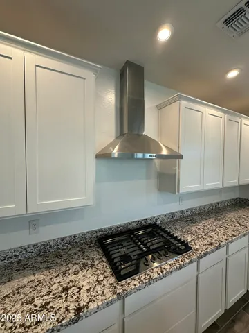 a stove top oven sitting inside of a kitchen