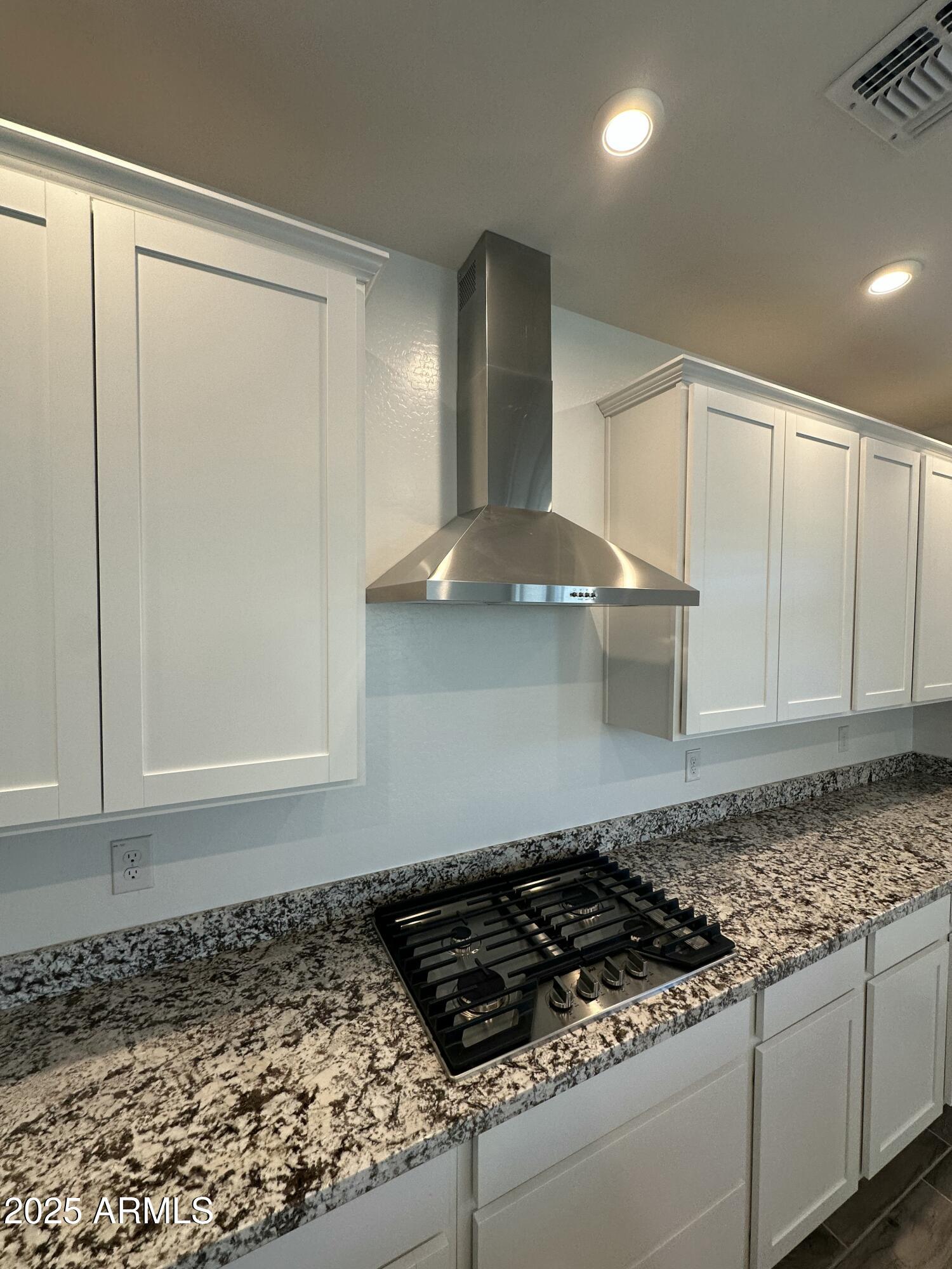 13330 West Eagle Feather Road Peoria, AZ 85383 - Photo 7 of 34 a stove top oven sitting inside of a kitchen