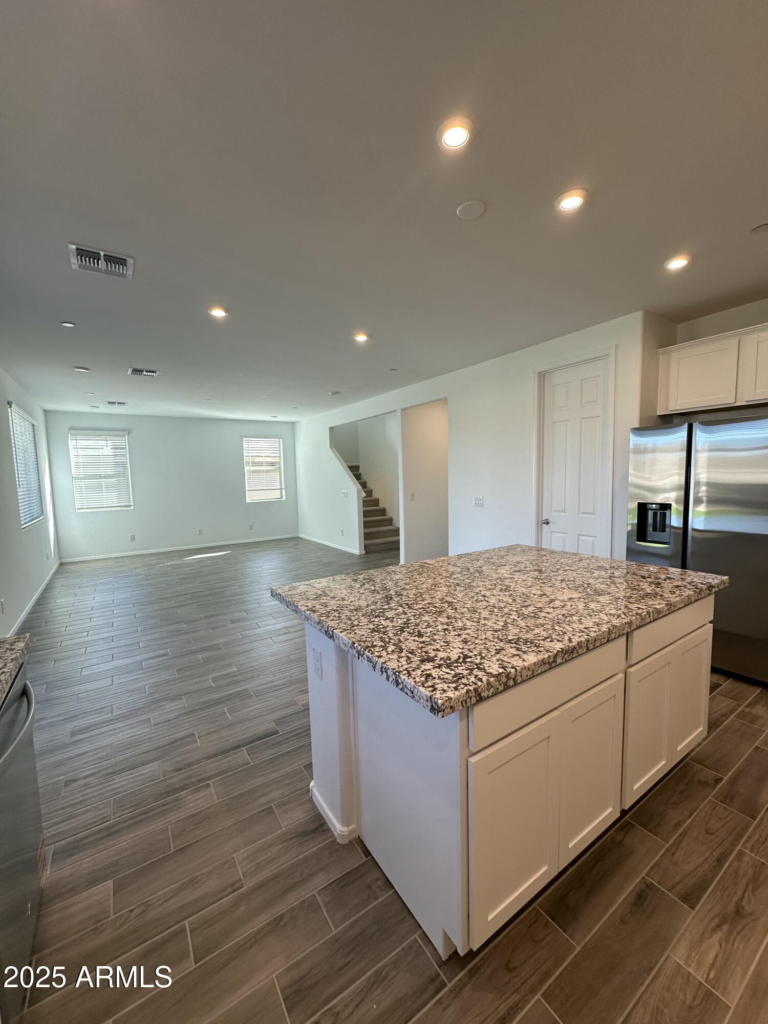 13330 West Eagle Feather Road Peoria, AZ 85383 - Photo 10 of 34 a kitchen with kitchen island a stove and wooden floor